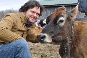 Leonard Nevarez and a cow at Sprout Creek Farm