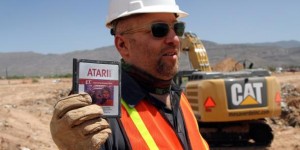 Figure 2: A member of the team holding the Atari 2600 game 'E.T. The Extra-Terrestrial' 