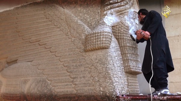 ISIS militant destroying a 3000 year old Assyrian Winged Bull