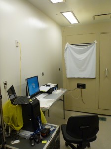 This is the computer and hardware we use for our experiments. The beige box is a large walk-in sound attenuating chamber.