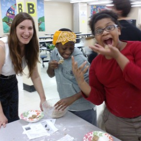 Rachel with the scholars Aaron and Desmarie making delicious cookie dough