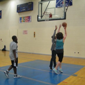 Michael goes for a lay-up while Keion tries to block him and Trevon looks on