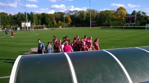 VAST Scholars huddled with the Vassar Women's Soccer Team before the game!